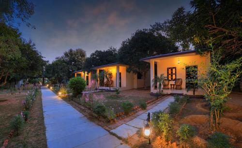 a house with lights on the side of a street at The Pugmark, A Wildlife Resort in Sawāi Mādhopur