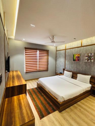 a bedroom with a large bed and a window at HR The nature resort in Birbhaddar