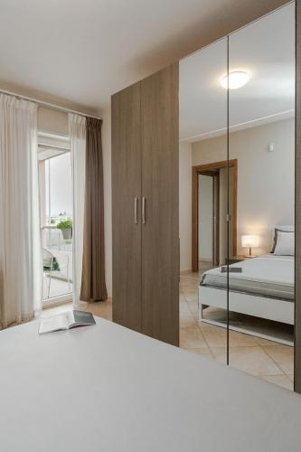 a bedroom with a bed and a mirror at Brezza di Mare Apartment in Scanzano