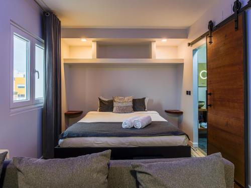 a bedroom with a bed with two pillows on it at Oceanway Apartment in the Center of Baleal in Ferrel