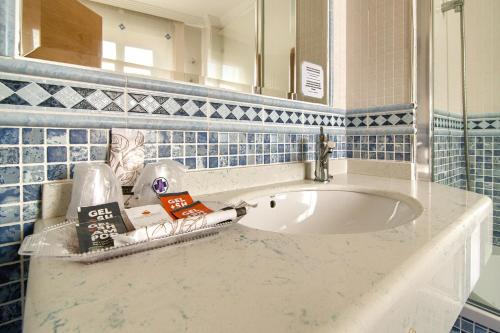 a bathroom with a sink and blue tiles at Pontus Veteris in Sanxenxo