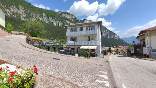 an empty street with a building on the side of a mountain at Apartments Giovannini in Fai della Paganella