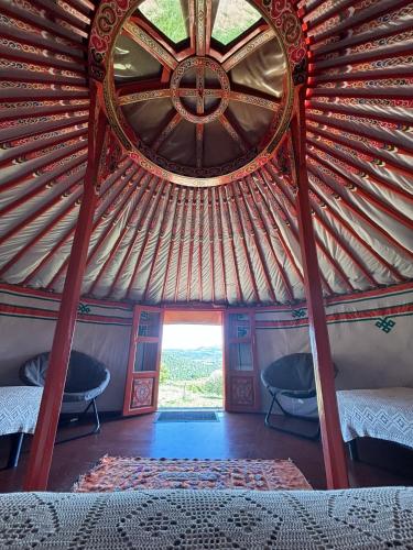 a view of a yurt with two beds and a window at Yourte Mongole Insolite - Gîte Saint Roch in Tuchan