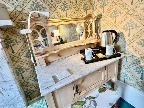 a bathroom with a vanity with a mirror at Dufferin Coaching Inn in Killyleagh