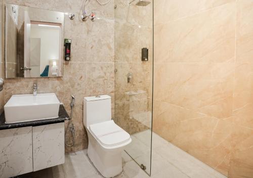 a bathroom with a shower and a toilet and a sink at Alpine Retreat in Narendranagar