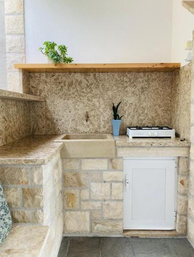 a kitchen with a counter top with a sink at Contessa robinson house in Korčula