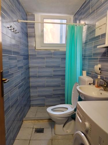 a bathroom with a toilet and a sink at Guest House LEA in Mostar