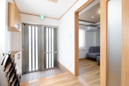 a hallway with a door leading to a living room at Casa Stay Kokura 2 - Vacation STAY 27406v in Itabitsu