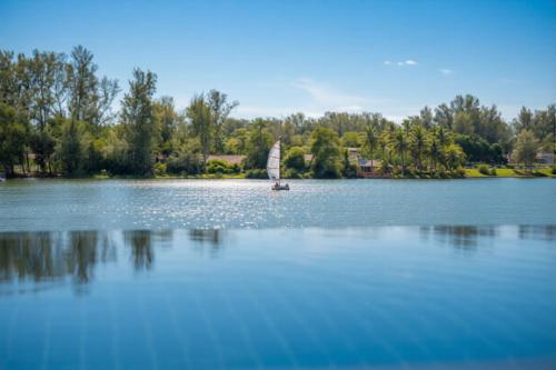 a small sail boat on a large lake at ANGSANA Oceanview Apartments with a privat pool in Laguna area in Bang Tao Beach