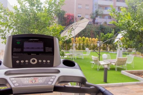 a fax machine sitting on a table in a garden at BLUESEA Dimona Suites in Torremolinos