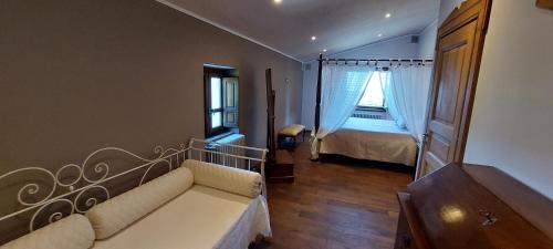 a living room with a couch and a bed at Villa Desideri Agriturismo Dinoabbo in Lucinasco