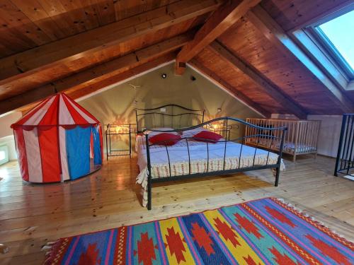 a bedroom with a bed and a tent in a attic at Hiža Bepina in Marčana