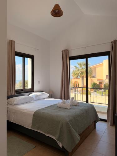 a bedroom with a bed and a large window at Casa Elea in Kouklia