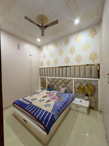 a bedroom with a bed and a ceiling at Karshni Kuteer in Mathura