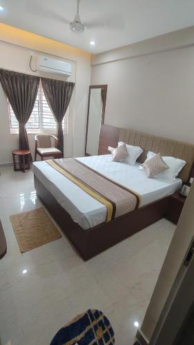a bedroom with a large bed in a room at COMFORT Inn in Subrahmanya