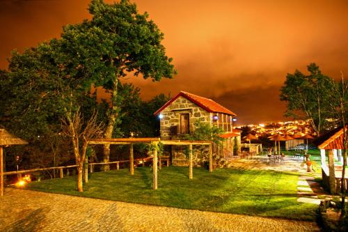 a cabin in the middle of a yard at night at Quinta da Costa in Lixa