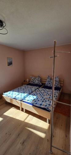 a bedroom with a bed with a blue comforter at Ferienwohnung Baumgartner in Aigen im Ennstal