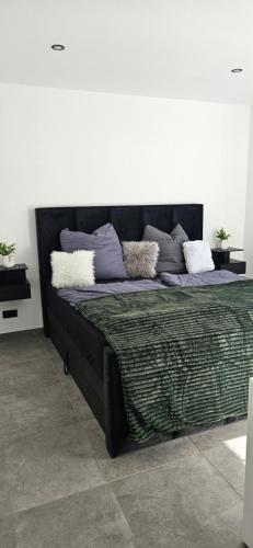 a bed with pillows on it in a room at Apartment nahe München A8 in Pfaffenhofen an der Glonn