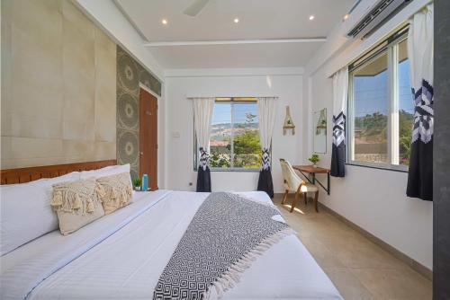 a bedroom with a large bed and a window at 6BHK White Castle Villa in Malavli