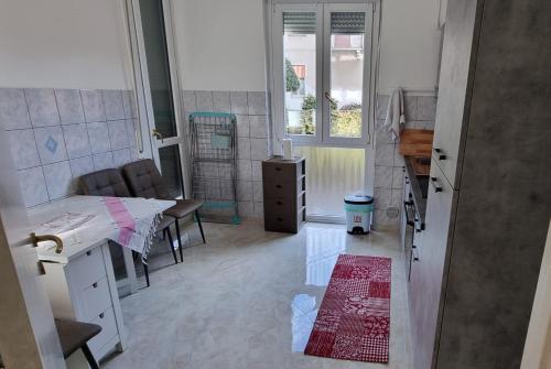 a room with a room with a table and a room with a table at Melis Apartment in Como