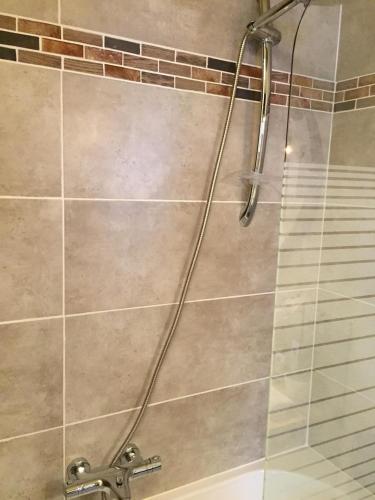 a shower with a hose in a bathroom at Maison Parnasse in Castelnau-de-Guers