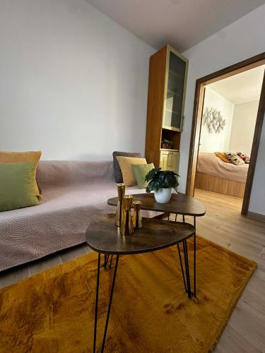 a living room with a couch and two tables at Apartmány Silvia in Dunajská Streda