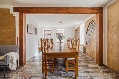 a dining room with a wooden table and chairs at Villa Pontis Rabštejn nad Střelou in Rabštejn nad Střelou