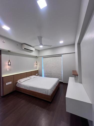 a bedroom with a large bed and a window at Skyline Serenia 23rd floor in Dehu Road