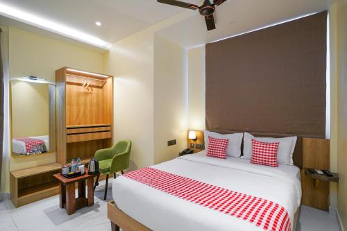 a bedroom with a large bed with red and white pillows at Open Hotel by Olive - Urban Suites in Bangalore