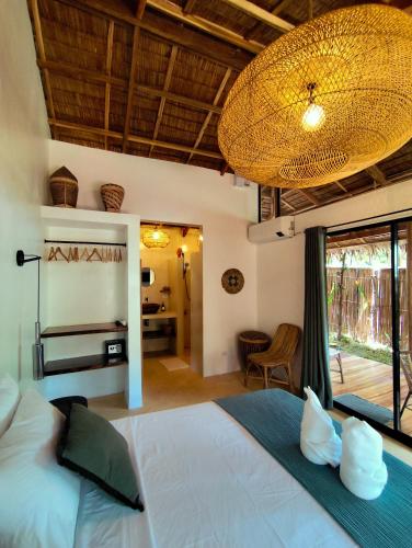 a bedroom with a large bed with a large window at Terracotta tropical nest in San Vicente