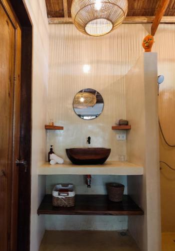 a bathroom with a sink and a mirror at Terracotta tropical nest in San Vicente