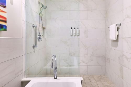 a white bathroom with a sink and a shower at SpringHill Suites Prescott in Prescott