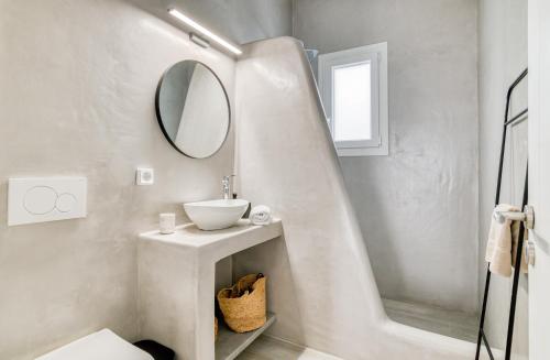 a white bathroom with a sink and a mirror at Villa Paros Spiti Mataki in Aliki