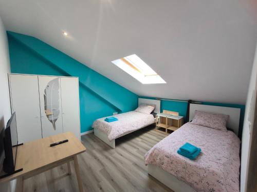 a bedroom with two beds and a television in it at Apartment Juliet in Izola