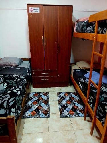 a room with two bunk beds and a cabinet at Departamento J&J 2 in Aristóbulo del Valle