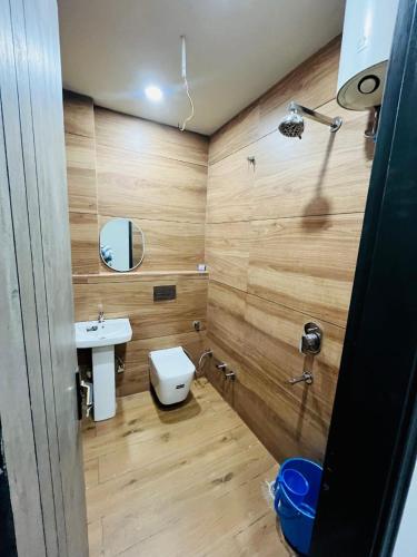a bathroom with a white toilet and a sink at Hotel Dream Stay in Pānīpat
