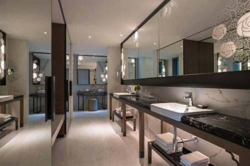 a bathroom with two sinks and a large mirror at Renaissance Taipei Shihlin Hotel in Taipei