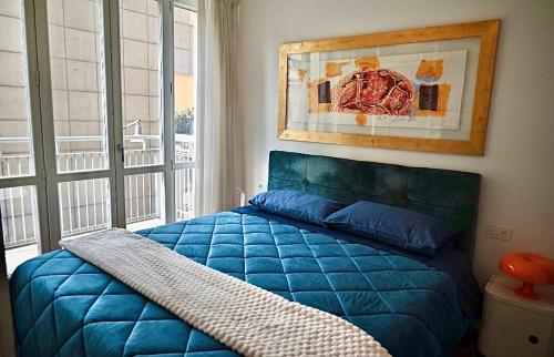 a blue bed in a bedroom with a window at Brera Elegant in Milan