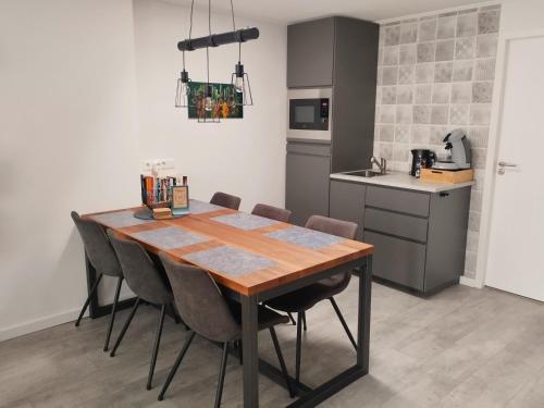 a kitchen with a wooden table and chairs at Family Inn Kaatsheuvel in Kaatsheuvel