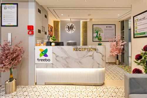 a reception area in a store with a marble counter at Treebo Arizona in Gandhinagar