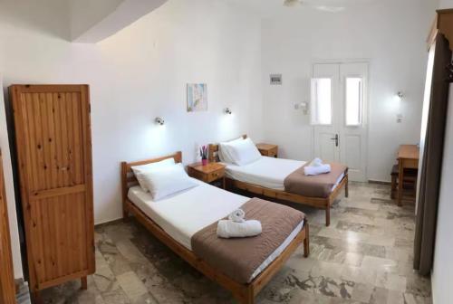 a hotel room with two beds in a room at Anemone Masouri in Masouri