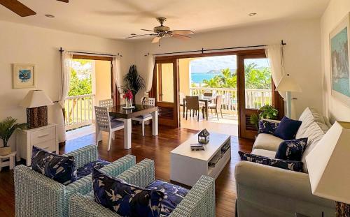 a living room with a couch and chairs and a table at Breathtaking Views Private 1 Bed Villa in Freetown Village