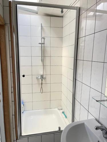 a bathroom with a shower and a bath tub at Deux chambres disponibles pour vous in Aalst