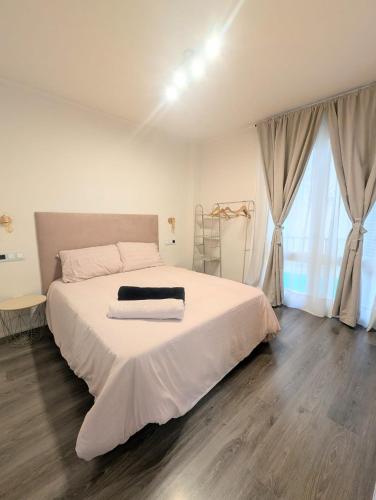 a bedroom with a large white bed with white sheets at Apartamentos Crispin Anais in Corella