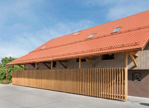 a building with a red roof on top of it at AlmRefugio in Neumarkt in der Oberpfalz