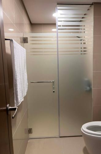 a shower with a glass door in a bathroom at The City Escape in Cebu City
