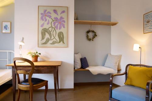 a room with a desk and a chair and a table at Schloss Blumenfeld in Tengen