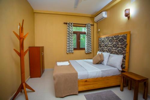 a bedroom with a large bed in a room at Serene Vista Villa, formerly Bungalows in Hikkaduwa