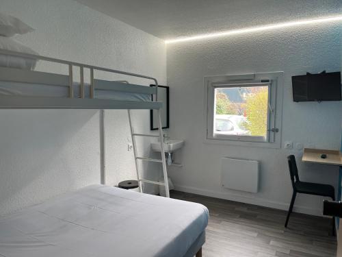 a bedroom with a bunk bed and a desk and a window at Unisotel Bollène A7 Ex-Hotel F1 in Bollène