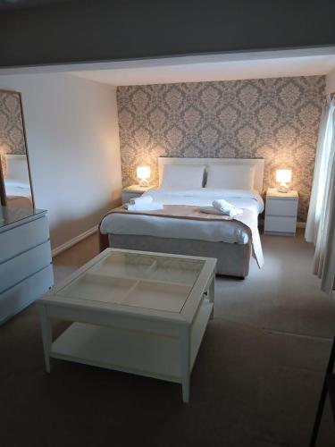 a bedroom with a bed and a coffee table at The Cross Oak Inn in Blackwood